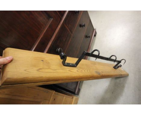 A pine wall hanging shelf with wrought iron game hooks