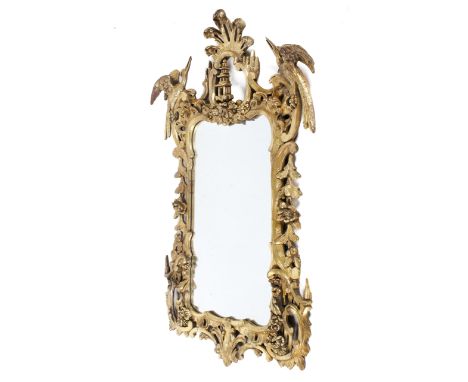A 20th century gilt framed wall mirror. The mirror mounted in an elaborate moulded frame topped with a pagoda finial and deco