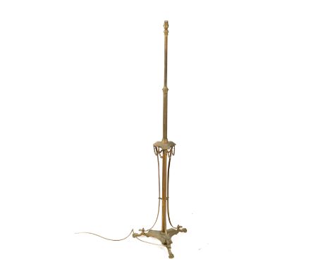 A Victorian brass adjustable standard lamp. Decorated with floral garlands, mounted on a tripod base with scroll feet, H147cm