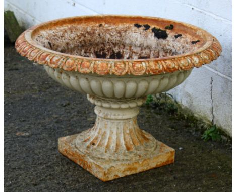 An antique cast metal garden urn. Having a moulded fluted edge, on a square base, H51cm x Diameter 76cm