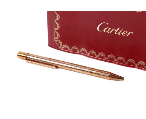 A Cartier pen. Numbered 156254, with a rose gold textured finish, 12.5cm long, in the original box with an instruction and ca