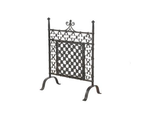A Victorian Arts & Crafts style wrought iron fire screen. The rectangular panel topped with finials and featuring flowers and