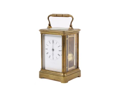A late Victorian brass cased carriage clock. The white enamel dial with Roman hours and inscribed beneath 'J. W. Benson', wit