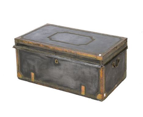 A leather bound travelling trunk. With brass bound edges and studded finish with camphour wood interior, with heavy brass han