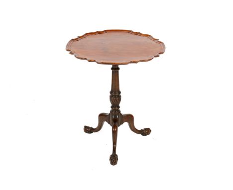 A 19th century mahogany tripod tilt top occasional table. With serpentine pie crust edge, over a turned and fluted pedestal, 