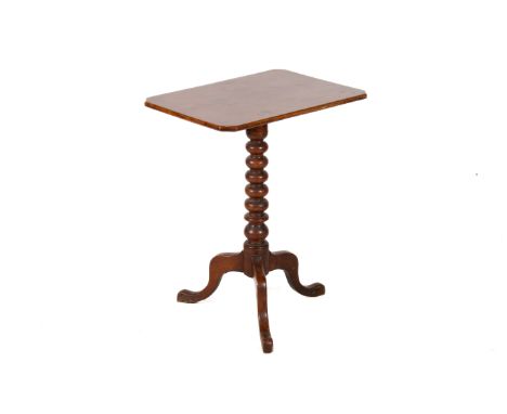 A Victorian mahogany tilt top table. The rectangular top with canted corners, mounted on a bobbin turned column terminating i