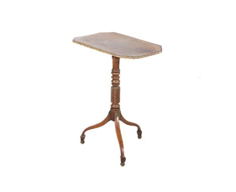 A Regency mahogany pedestal table. The octagonal top having a moulded gilt edge, mounted on a turned and twist columns with a