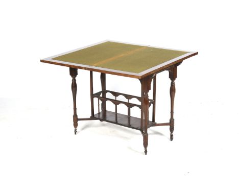 An Edwardian rosewood fold over card table. The swivel top enclosing a green baize lined playing surface, raised on four turn