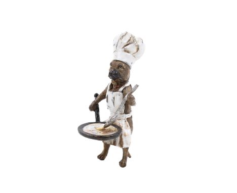A Bergman Austrian cold painted bronze novelty model of a pug. Dressed in a chef's hat and apron and frying an egg in a pan, 