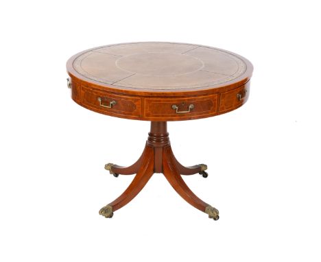 A Georgian style mahogany drum table. Having a brown leather insert to the top, with eight frieze drawers, on a baluster colu