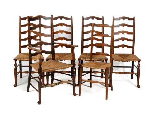 Six oak ladder back chairs. Comprising a set of four dining chairs, a carver chair and one other, all having rush seats and r