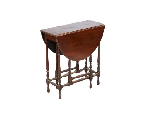 A 19th century mahogany gate leg table. Having an oval top, raised on turned supports united by stretchers, H69cm x W89cm x D