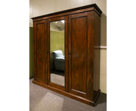 An early to mid 19th century Victorian mahogany linen press and wardrobe. Having a pediment top, the left panelled door and c