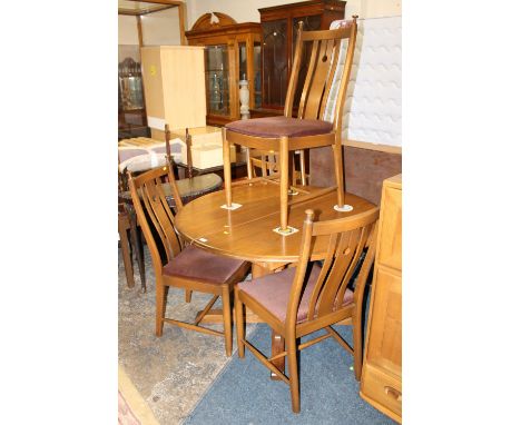 AN ERCOL ELM AND BEECH EXTENDING DINING TABLE AND FOUR CHAIRS
