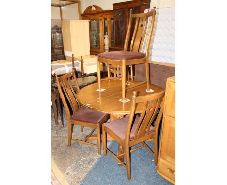 AN ERCOL ELM AND BEECH EXTENDING DINING TABLE AND FOUR CHAIRS