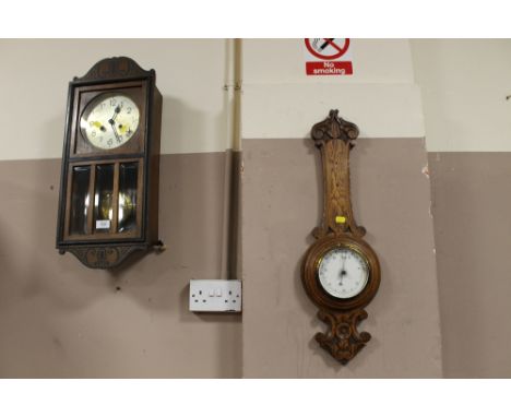 AN EDWARDIAN OAK WALL CLOCK TOGETHER WITH A BAROMETER