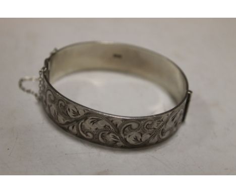 A HEAVY ENGRAVED SILVER BANGLE