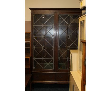 A LARGE OAK CHIPPENDALE STYLE LEAD GLAZED BOOKCASE