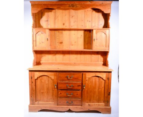 Pine dresser, moulded cornice, panelled back with two shelves and spice cupboards, the base with a rectangular top, moulded e
