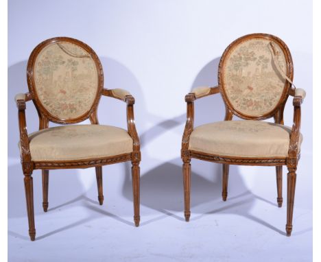 Pair of French walnut fauteuil, 20th Century, oval backs, carved acanthus arms, bowfront seat, turned and fluted legs, tapest