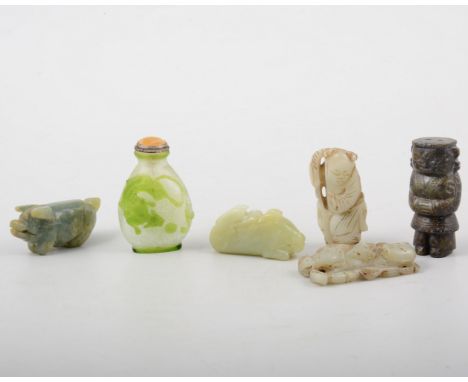 Two carved jade weights, three small figures, and a snuff bottle.