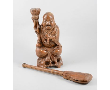A carved wooden Buddha, 30cm and a wooden opium scales set with bone balance and metal pans, case 38cm long. (2)