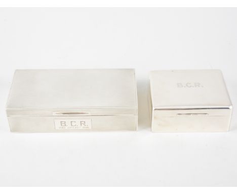 Two silver cigarette/jewel boxes, one engine turned 18cm x 9cm, hallmarked Birmingham 1947, the other plain polished finish 9