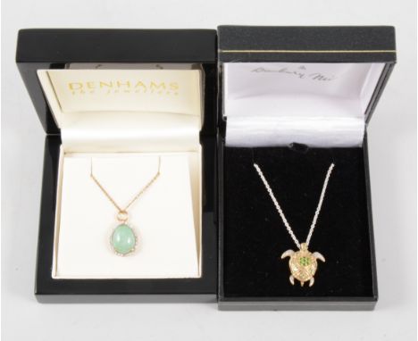 Two pendants and chains, a pear shaped green cabochon jade surrounded by small diamonds claw set in a yellow metal mount 15mm