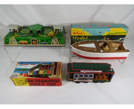 A 1960s tin-plate clockwork City Buses Made in West Germany, a San Francisco tin-plate cable car in original box and a K Toys