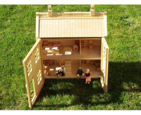 A wooden doll house by Chad Valley, partly furnished with three residents, 60cm x 52cm x 23cm, missing front door Est £20 - £