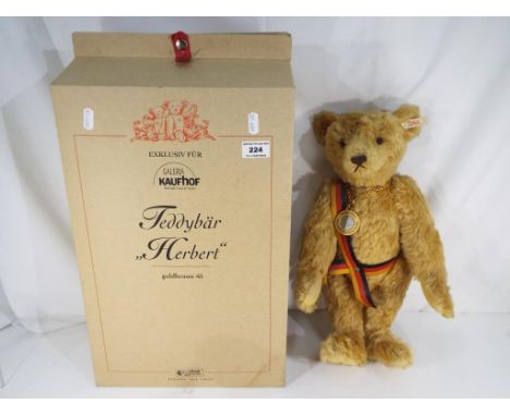 Steiff - A limited edition Steiff commemorative, mohair bear 'Herbert', with growling mechanism, pendant and German flag sash