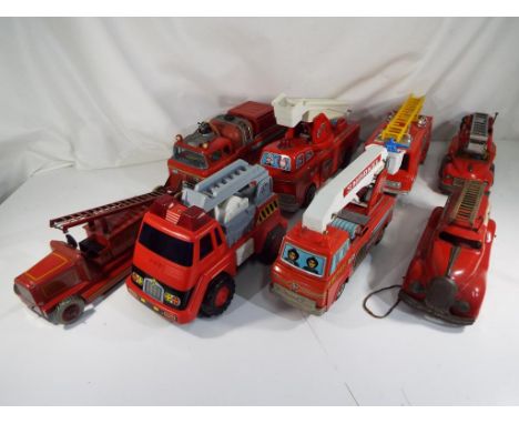 Fire Engines - A good selection of eight friction and battery powered fire engines from TN Japan, Chad Valley and others, all