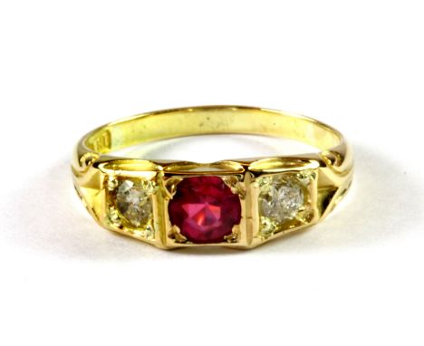 An 18ct yellow gold ring set with a brilliant cut ruby and diamonds, (J).