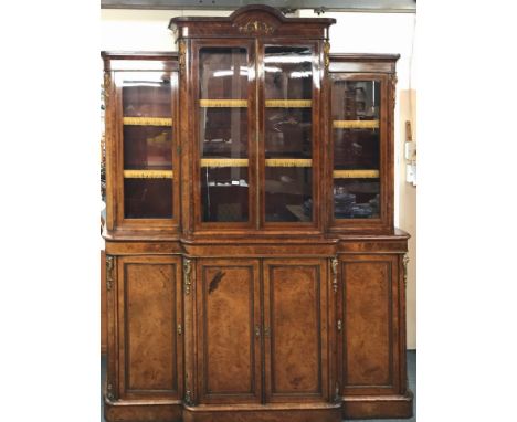 A superb French ormolu mounted and burr walnut veneered bookcase with cabinet below c. 1900, W. 182cm, H. 242cm.