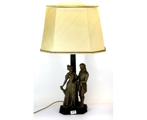 An early 20th Century spelter figural table lamp with silk shade, H. 73cm.