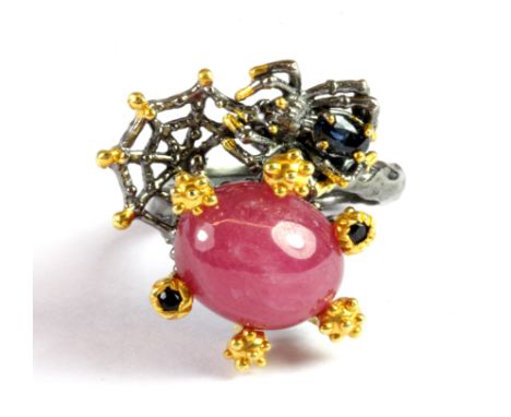 A Hana Maae 925 silver gilt ring set with sapphires and a large cabochon cut ruby, (N).