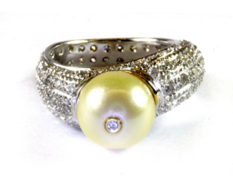 A white metal (tested 18ct gold) diamond and pearl set ring, (K).