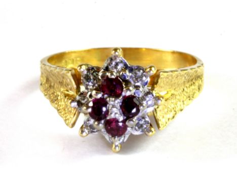An 18ct yellow and white gold ruby and diamond cluster ring, (S).