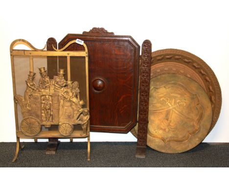 A 1920's Dickensian metal fire screen, an oak fire screen and two brass trays.