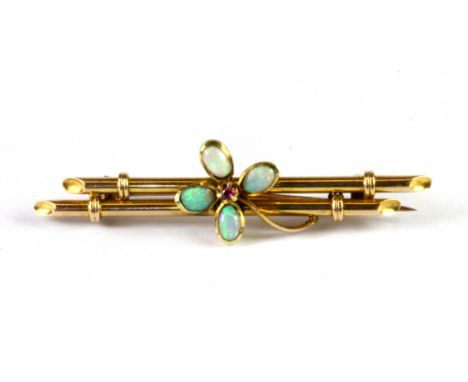 An Edwardian 15ct yellow gold (stamped 15ct) opal and ruby set bar brooch, L. 5cm.