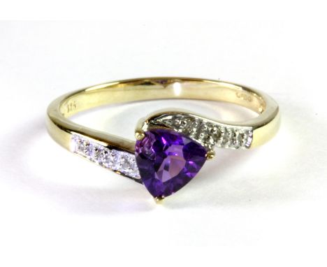 A 9ct yellow gold ring set with a trillion cut amethyst and diamond set shoulders, (P.5)