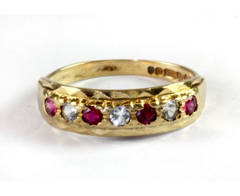 A 9ct yellow gold ruby and white stone set ring, (O).