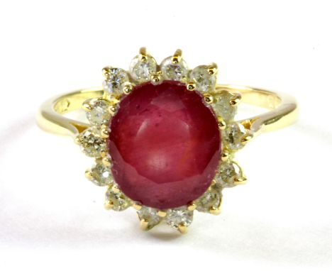 An 18ct yellow gold cluster ring set with a 4ct oval cut ruby and diamonds, (P.5).