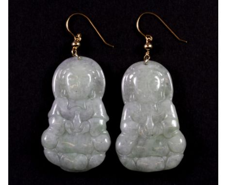 A pair of yellow metal (tested 9ct gold) mounted carved jade drop earrings, L. 6cm.