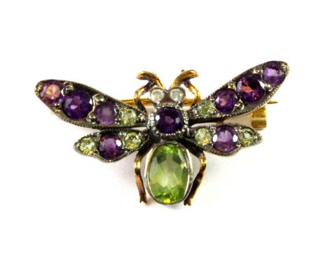 Suffragette interest. An Edwardian yellow and white metal (tested silver and gold) insect shaped brooch set with peridot, ame