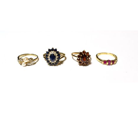 A sapphire and diamond cluster ring, stamped '9K', finger size P; a 9 carat gold garnet cluster ring, finger size N1/2; a 9 c