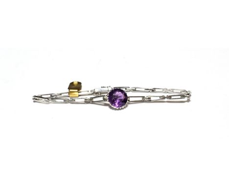 An amethyst and diamond bracelet, a round cut amethyst in a white claw setting, to tapering gate links, the first sections jo