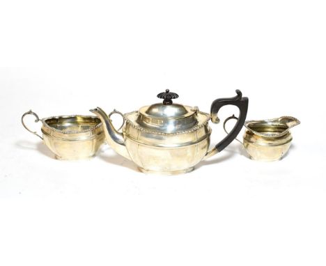 A silver three piece tea service 