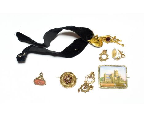 A collection of jewellery including a Victorian cabochon garnet pendant; a pair of yellow metal star drop pendant earrings; w