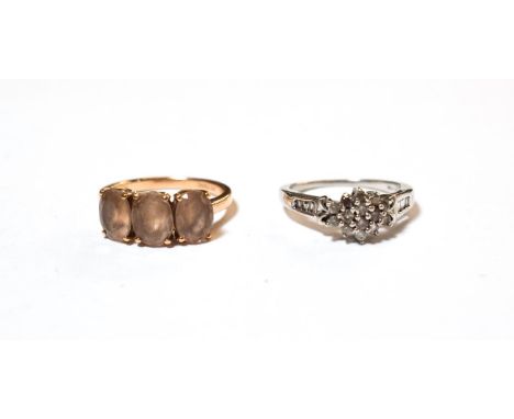 A 9 carat gold diamond cluster ring, finger size N; and a 9 carat gold smokey quartz three stone ring, finger size N.  Gross 